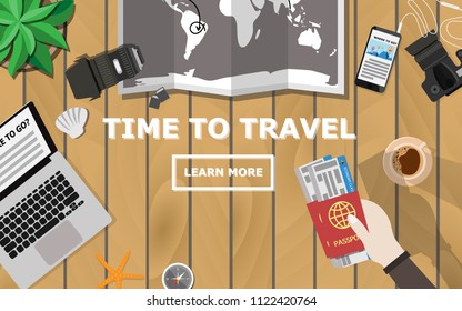 Top Down Flat Lay View Of Wooden Table With Laptop, Camera,lens,mobile Phone,coffee,hand Holding Passport And Plane Ticket,world Map,compass,tree And Copy Space For Text