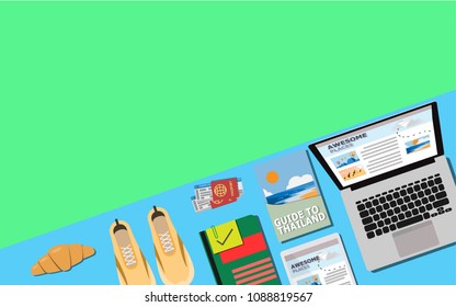 Top Down view of laptop,travel book,tablet,notebook,passport with plane ticket,sport shoes,croissant with copy space for your text on pastel color of blue with green for wallpaper,background,backdrop