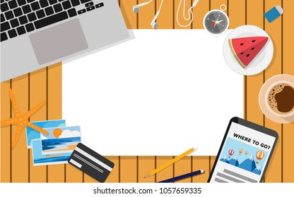 Top down view of table with empty paper-copy space- for your text surrounded with laptop,water melon,mobile phone,photos,credit card,coffee,compass,earphones and pencil place on the wooden table
