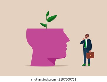 Top of head cut off and green sprout growing from it. Growing trees. Green Space expansion. Young man in suit, looking up and thinking with hand. Eco-friendly businesses.