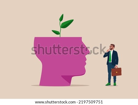 Top of head cut off and green sprout growing from it. Growing trees. Green Space expansion. Young man in suit, looking up and thinking with hand. Eco-friendly businesses.