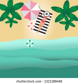 The top view of the beach has coconut trees and women sunbathing on the mats and rubber rings.