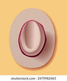 Top view beige wide-brimmed hat with red trim on yellow background summer accessory fashion