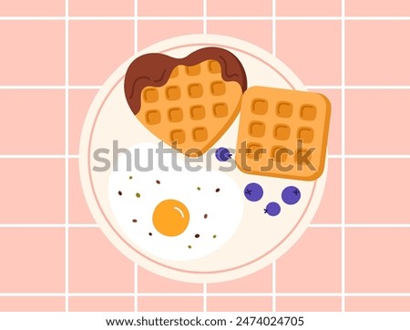 Waffle ingredients top view, isolated on a blue background