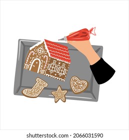 Top view christmas composithion with a hand decorating gingerbreads. Baking christmas gingerbread house on a tray background. Concept of holiday baking of cookies. Vecor illustration