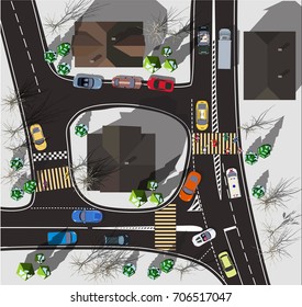 Top view crossroads in a small town. Workers are repairing the road in winter with grey snow