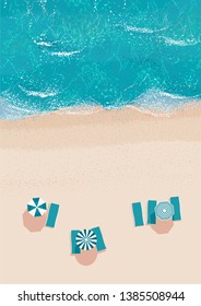 top view of a deserted beach with sun loungers and parasols and a light blue sea