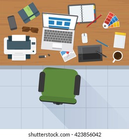 Top view of designer working desk with stuff and laptop