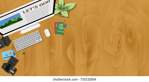 Top view of desk of traveler with computer planing for the next trip and camera, lens,  memory card, and passport with pot of green small tree