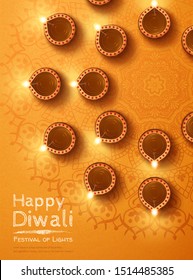 Top view of diwali design with oil lamps rangoli on chrome yellow background