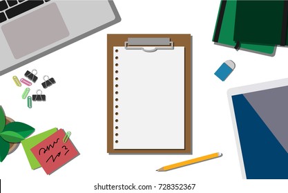 Top view of empty paper note on working desk with laptop, mobile phone, and tablet with copy space for your own text