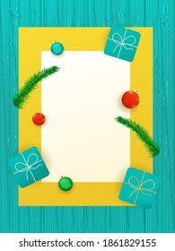 Top View Of Gift Boxes With Baubles, Fir Leaves And Empty Card Given For Text On Turquoise Wood Texture Background.
