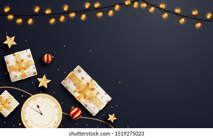 Top view of gift boxes with wall clock, golden stars and lighting garland decorated on black background with space for your text.