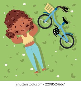 Top view of girl lying on the grass with bicycle 