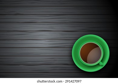 Top view of green cup of coffee or tea on the table black wood with space for text