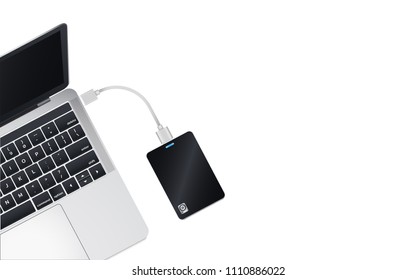 Top view a half of modern laptop computer Connect with Portable 2.5 inch External Harddrive via USB Cable Isolate on white background.Copy space for insert content.