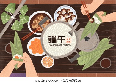 Top view of hands wrapping rice dumplings for holiday with all the ingredients placed on wooden table, Dragon boat festival on May 5th written in Chinese words