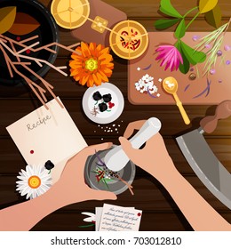 Top view - hands,mortar and pestle on wooden table with herbs, a recipe, flowers - marigold, chammomile, rosemary. Weight scale, knife for herbs. Homeopathy, alternative medicine, pharmacy background