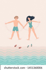 top view of happy man and woman lie on the beach on the sand by the sea. Smiling newlyweds on vacation at sea. A woman in a green bathing suit and a man in green swimming trunks are having fun.