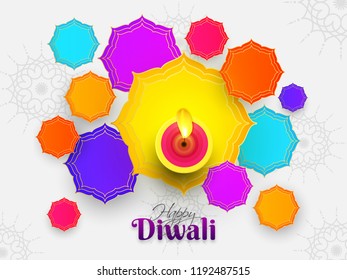 Top view of illuminated oil lamp with colorful abstract design on white background for Indian Festival Diwali celebration. Can be used as greeting card design.