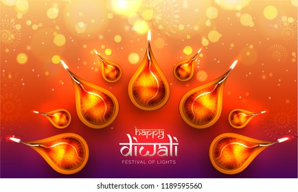 Top view of illuminated realistic oil lamps on shiny blurred background with stylish lettering of Happy Diwali. Can be used poster or banner design. 