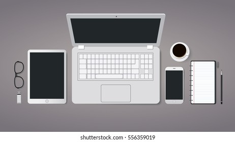 Top view laptop computer with mobile phone and tablet on office desk. Modern workplace