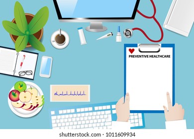 Top view of a medical table with doctor accessories. Doctor is holding blank paper with preventive healthcare sign. 