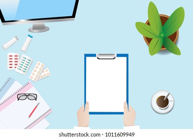 Top view of a medical table with doctor's hands holding blank paper ready for your text. 