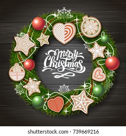 Top view of Merry Christmas concept design. Christmas wreath with cookies on wooden background. Christmas food