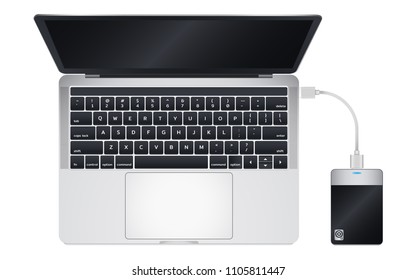 Top view of modern laptop computer Connect with Portable 2.5 inch External Harddrive via USB Cable Isolate on white background.