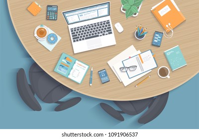 Top view of modern stylish round wooden desk in office, chairs, office supplies, laptop, folder, headphones, phone, pen, paper, coffee, tea, book. Vector illustration 