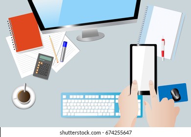 Top view of the office desk with coffee cup, blank notepad and papers with pen. Hands are holding and touching a smart phone with empty screen ready for your text.