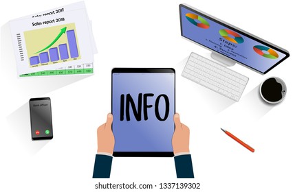Top view on hands with laptop with text Info above desk with mobile, tablet and other business accessories. Modern business workplace