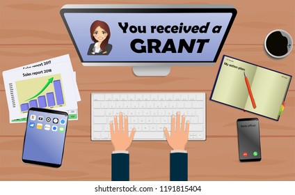 Top view on laptop computer with text you received a grant with mobile phone and tablet on office desk. With Business notebook (diary) with text action plan. Modern business workplace