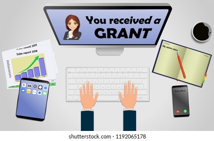 Top view on laptop computer with text you received a grant with mobile phone and tablet on office desk. With Business notebook (diary) with text action plan. Modern business workplace