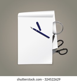 Top view on office table with open notepad, magnifying glass, scissors and fountain pen.
