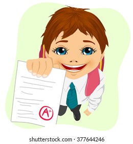 top view of schoolboy showing his test paper isolated on green background