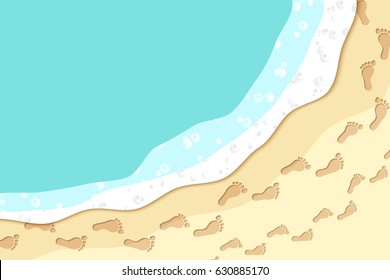 Top view of seashore with sea waves and footprints in the sand.