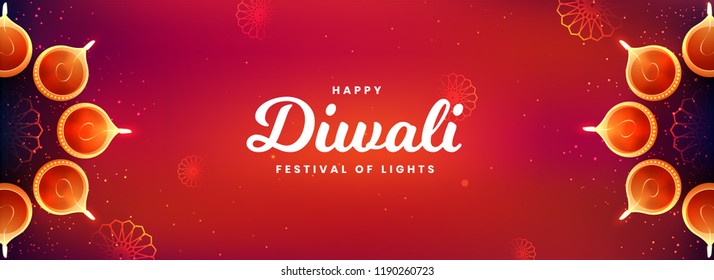 Top view of social media header or banner design decorated with illuminated oil lamps on glossy red background for Happy Diwali celebration.