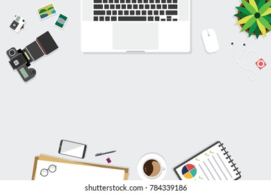 Top view of table working and working desk with gadget and free space for text with accessory on the table, note, phone, keyboard, camera, pen, flowerpot, laptop, tablet