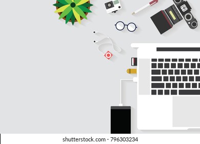Top view of table working and working desk with gadget and free space for text with accessory on the table, notebook, phone, camera, flowerpot, laptop, tablet