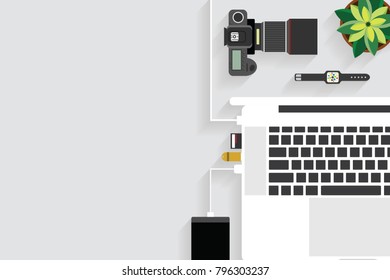 Top view of table working and working desk with gadget and free space for text with accessory on the table, notebook, phone, camera, flowerpot, laptop, tablet