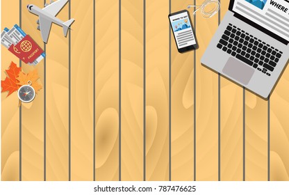 Top view of the terrace with laptop Andy mobile phone search for the travel destination and economy class plane ticket with passport and red maple leaves with copy space for text