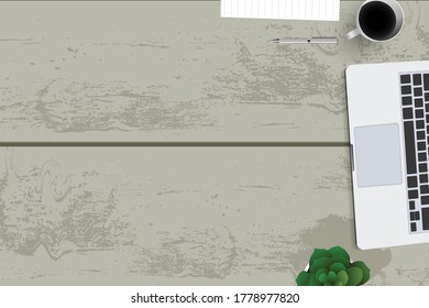 Vista superior con mesa texturizada, portátil y teléfono, así como libros y ratón y café. En el centro de la tabla hay una placa de carpeta con hojas blancas para el texto