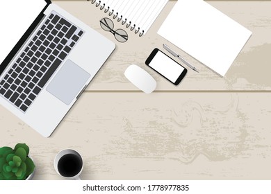 Top view with textured table, laptop and telephone as well as books and mouse and coffee. In the center of the table is a folder-plate with white sheets for your text