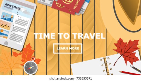 Top view of traveler desk, plan for the trip with empty notebook and copy space for text on wooden table,maple leaves,compass,tablet finding dream destination, passport with economy plane ticket