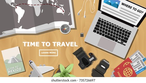 Top view of traveler's wooden desk with laptop planing for the next trip to Mexico, world's map, dslr camera with lens,economy class plane ticket and passport with copy space for your own text