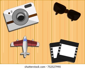 Top view of travelling objects set on wooden background. Flat lay.