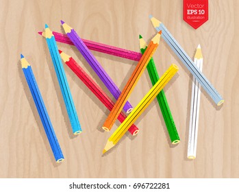 Top view vector illustration of color pencils on light wood desk background.