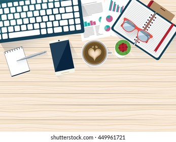 Top view of wooden worktable with elements, coffee latte art and cactus